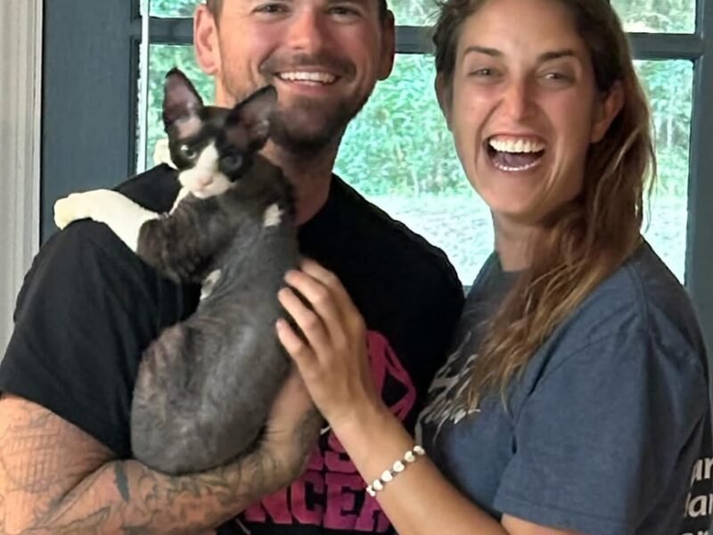 A family at home with their adopted Devon Rex cat